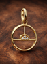 Sunrise Medallion Charm — display on walnut