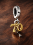 Gold Plated Ribbon Tools Charm - Gold Plated Ribbon Tools Charm — display on walnut