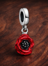 Red Flower Dangle Charm — display on walnut