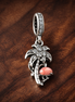 Miami Dangle Charm — display on walnut