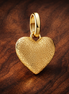 Engravable Heart Medallion Charm — display on walnut