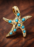 Sparkling Blue Starfish Dangle Charm — display on walnut