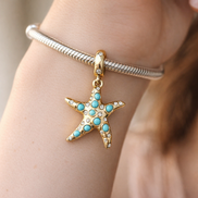 Sparkling Blue Starfish Dangle Charm — worn on wrist