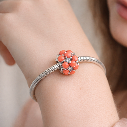 Coral-colored Ocean Charm — worn on wrist