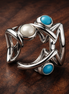 Openwork Fish Charm — display on walnut