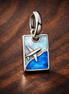 Opal Airplane Tag Charm - Opal Airplane Tag Charm — display on walnut