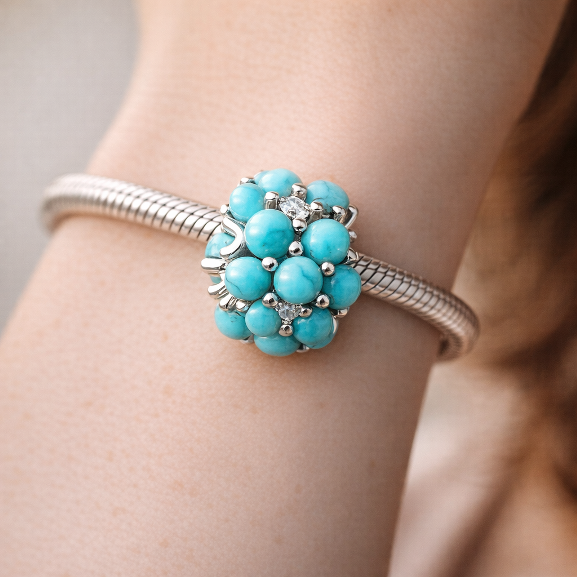 Turquoise-colored Ocean Charm — worn on wrist