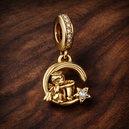 Gold Plated Moon Fu Dangle - Gold Plated Moon Fu Dangle Charm — display on walnut
