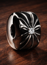 Sparkling Sunburst Clip Charm — display on walnut