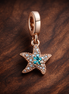 Sparkling Starfish Dangle Charm — display on walnut