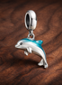 Blue Dolphin Dangle - Silver Dolphin Splash Dangle — display on walnut