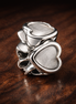 Open Heart Spacer - Sterling Silver Open Heart Spacer Charm — display on walnut