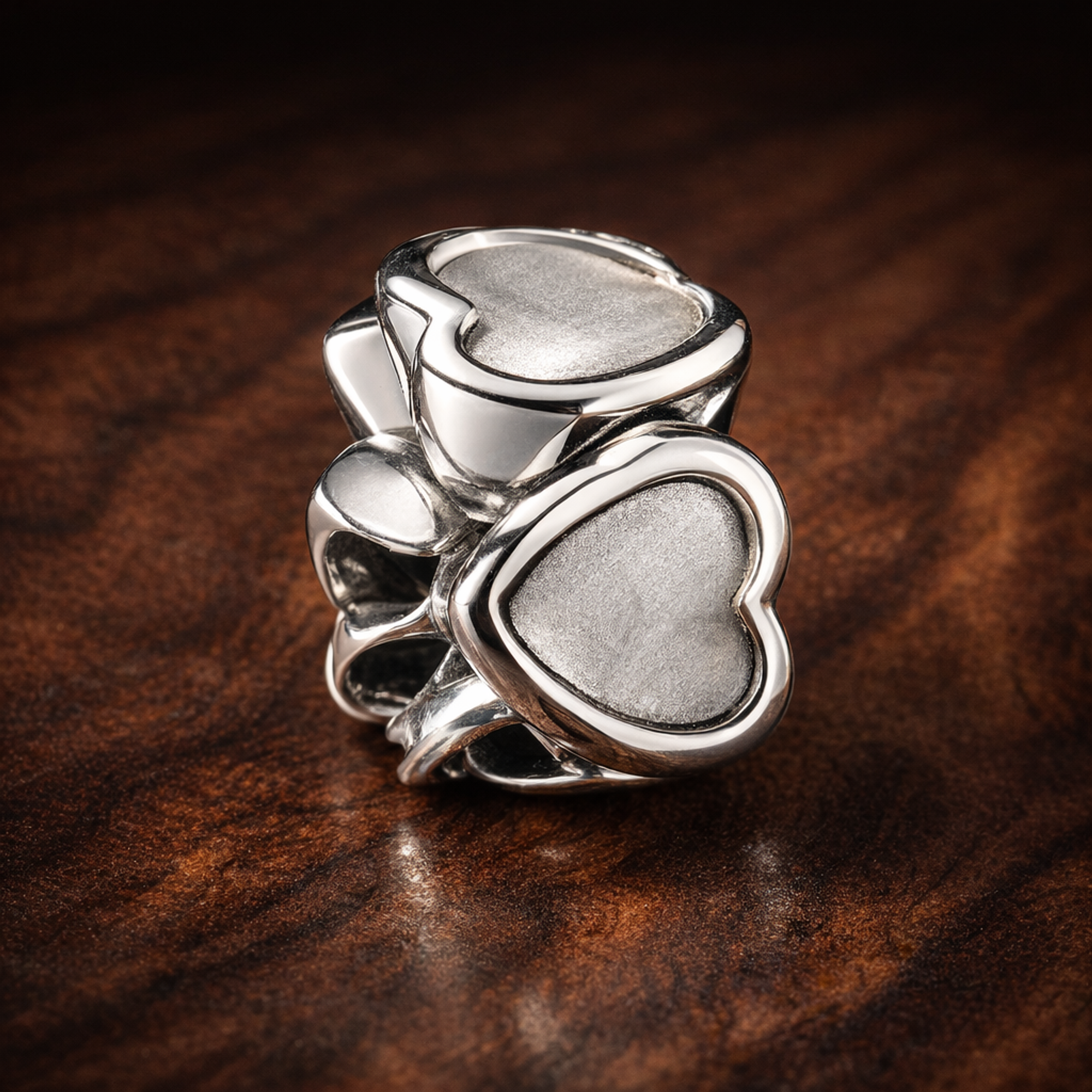 Open Heart Spacer - Sterling Silver Open Heart Spacer Charm — display on walnut