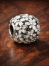 Silver Bubble Openwork - Polished Bubble Openwork Charm — display on walnut