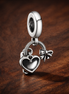 Pandora Shopping Bag Dangle Charm — display on walnut
