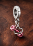 Dumbbell & Heart Dangle Charm — display on walnut