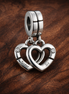 Linked Sister Hearts Split Dangle Charm — display on walnut