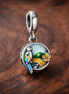 Tropical Parrot Dangle - Parrot Island Dangle Charm — display on walnut