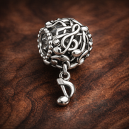 Silver Music Note Dangle - Treble Note Music Dangle Charm — display on walnut