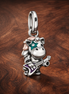 Skater Unicorn Charm - Playful Unicorn Skate Charm — display on walnut