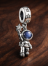 Astronaut Blue Planet Dangle Charm - Astronaut Blue Planet Dangle Charm — display on walnut