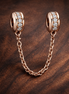 Rose Gold Plated Safety Chain Charm - Rose Gold Plated Safety Chain Charm — display on walnut
