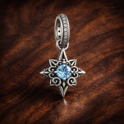 Blue North Star Dangle Charm - Blue North Star Dangle Charm — display on walnut