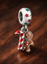 Gingerbread Man Dangle Charm — display on walnut