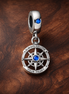 Blue Compass Dangle Charm - Blue Compass Dangle Charm — display on walnut
