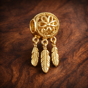 Gold Plated Dreamcatcher Feather Charm - Gold Plated Dreamcatcher Feather Charm — display on walnut