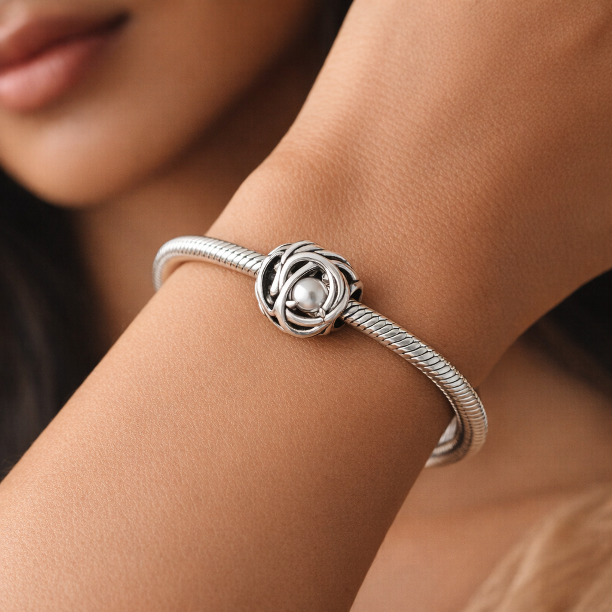 April Clear Eternity Circle Charm — worn on wrist