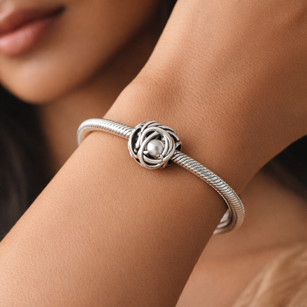 April Clear Eternity Circle Charm — worn on wrist