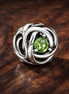 August Spring Green Eternity Circle Charm — display on walnut