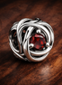 July True Red Eternity Circle Charm — display on walnut