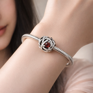 July True Red Eternity Circle Charm — worn on wrist