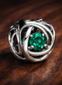 May Green Eternity Circle Charm — display on walnut