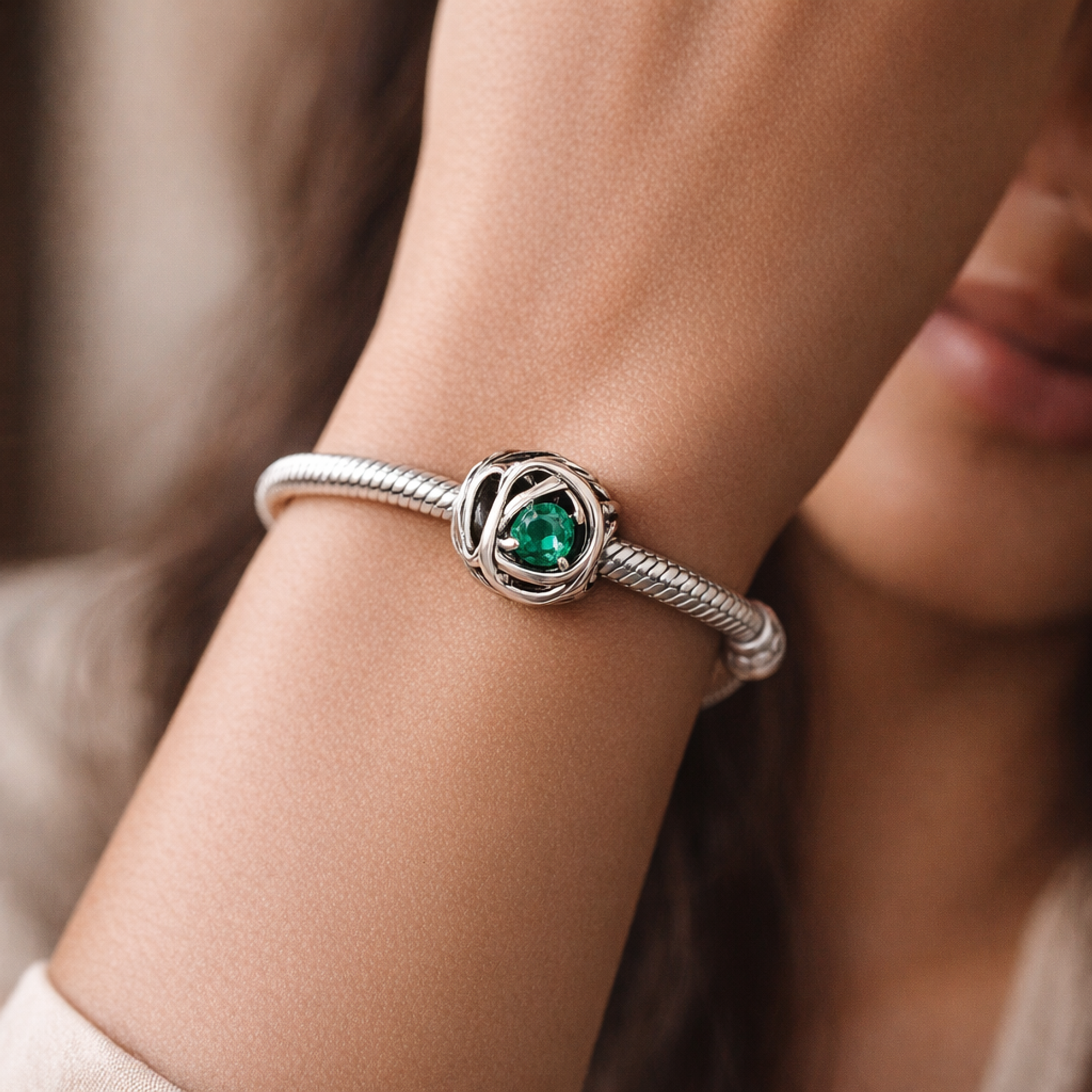 May Green Eternity Circle Charm — worn on wrist