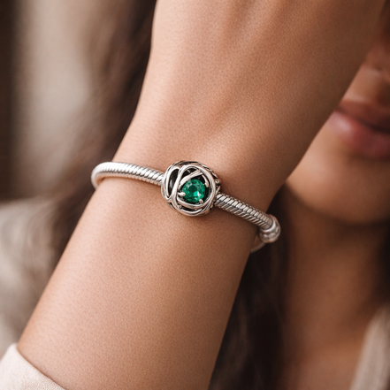 May Green Eternity Circle Charm — worn on wrist