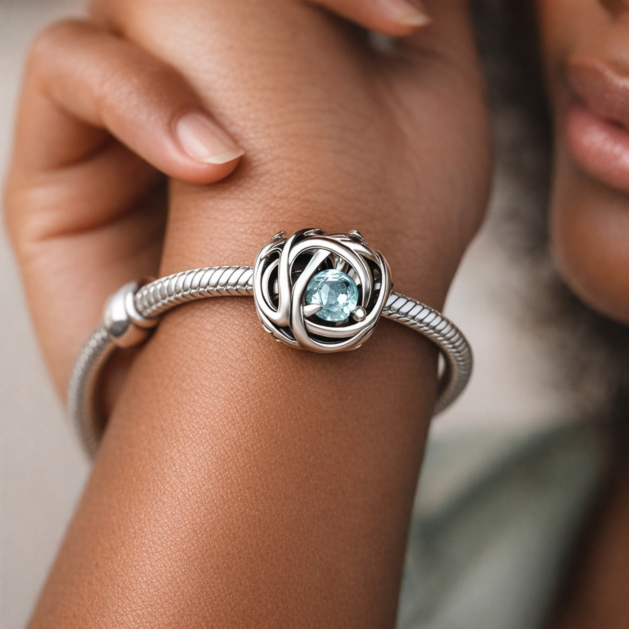 March Sea Aqua Blue Eternity Circle Charm — worn on wrist