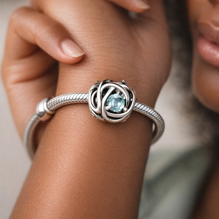 March Sea Aqua Blue Eternity Circle Charm — worn on wrist
