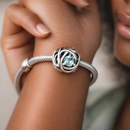 March Sea Aqua Blue Eternity Circle Charm — worn on wrist
