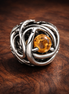 January Red Eternity Circle Charm — display on walnut