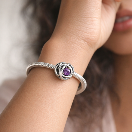 February Purple Eternity Circle Charm — worn on wrist