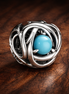 December Turquoise Blue Eternity Circle Charm — display on walnut