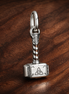 Marvel The Avengers Thor's Hammer Dangle Charm — display on walnut