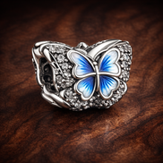 Blue Butterfly Sparkling Charm — display on walnut