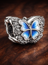 Blue Butterfly Sparkling Charm — display on walnut