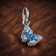 Blue Butterfly & Quote Double Dangle Charm — display on walnut