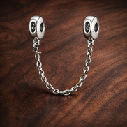 Silver Beaded Safety Chain Charm - Silver Beaded Safety Chain Charm — display on walnut
