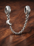 Moon Star Safety Chain Charm - Moon Star Safety Chain Charm — display on walnut